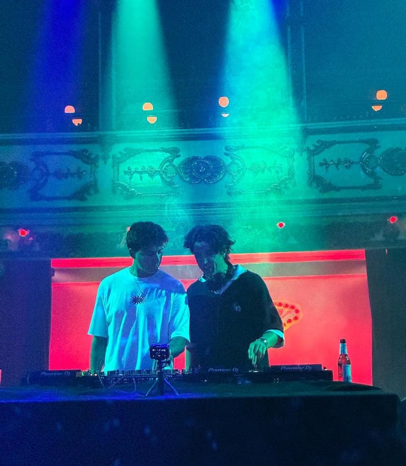 State Of Mind playing under blue and green lights